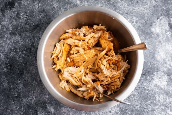 shredded chicken in a bowl with two forks