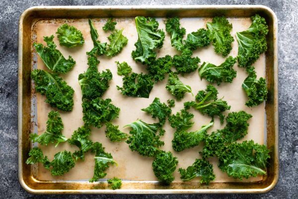 kale chips spread out on sheet pan