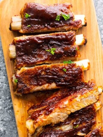 close up view of instant pot ribs, cut and laid out on cutting board