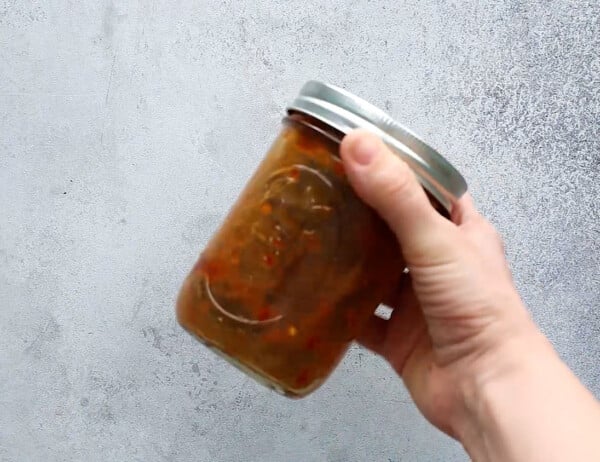 shaking up the sweet chili stir fry sauce in a jar