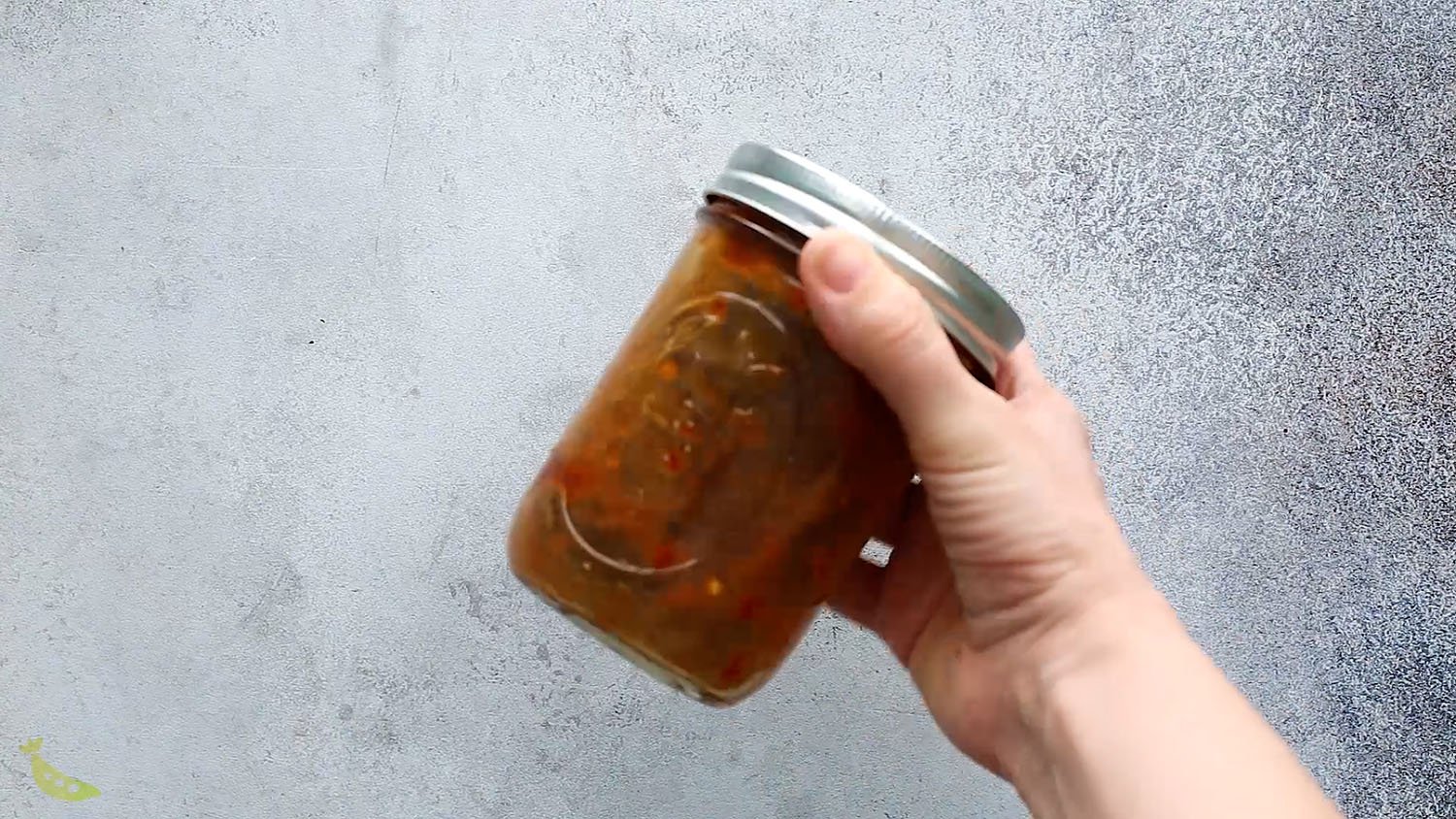 shaking up the sweet chili stir fry sauce in a jar