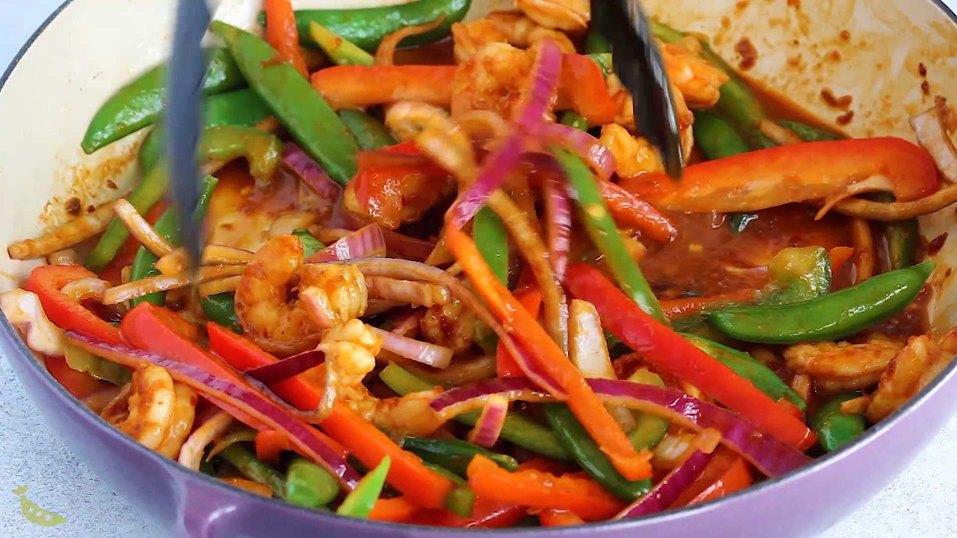 tossing shrimp and vegetables in sweet chili stir fry sauce