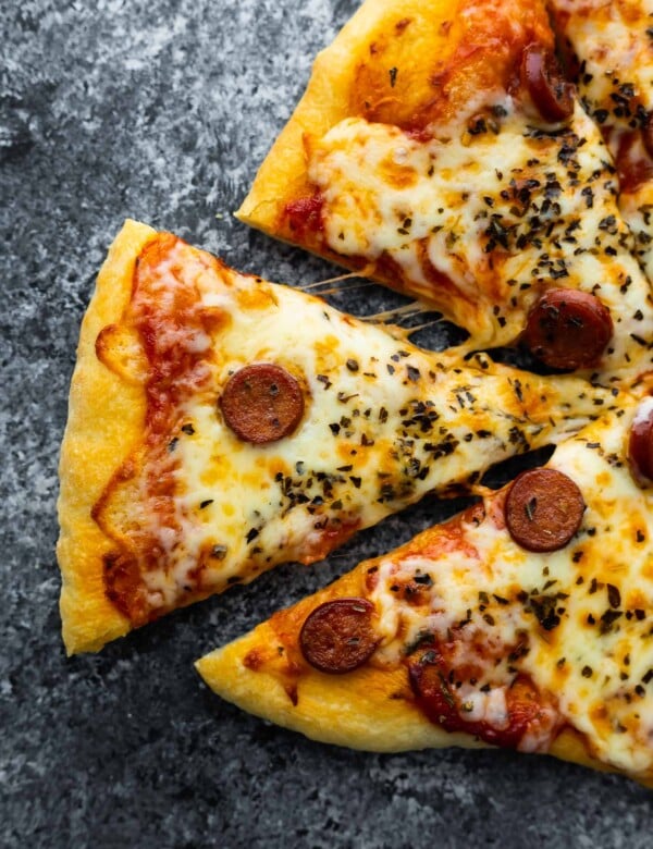 close up view of pizza slice being pulled away
