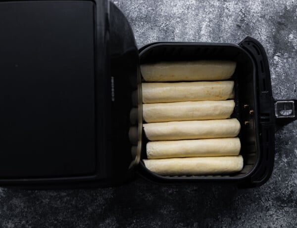 taquitos rolled up and layered in air fryer