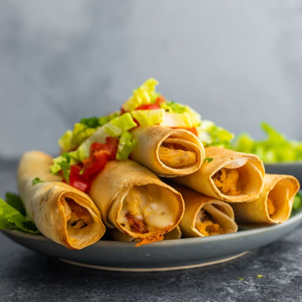 side angle view of plate stacked with taquitos