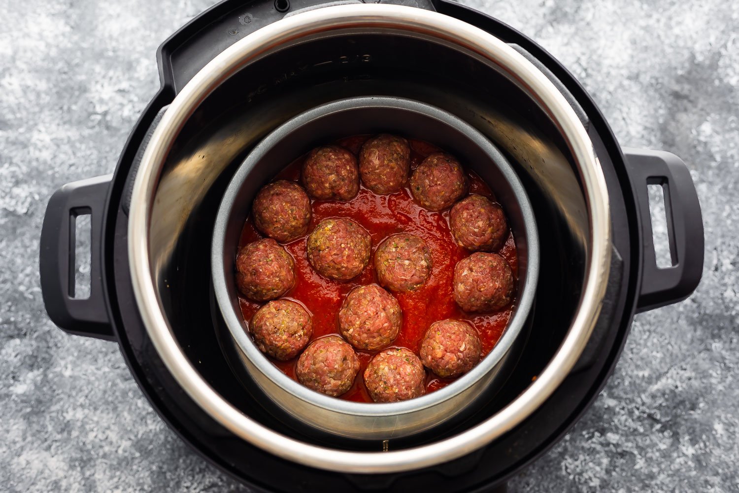 meatballs in marinara sauce inside a cake pan in the instant pot