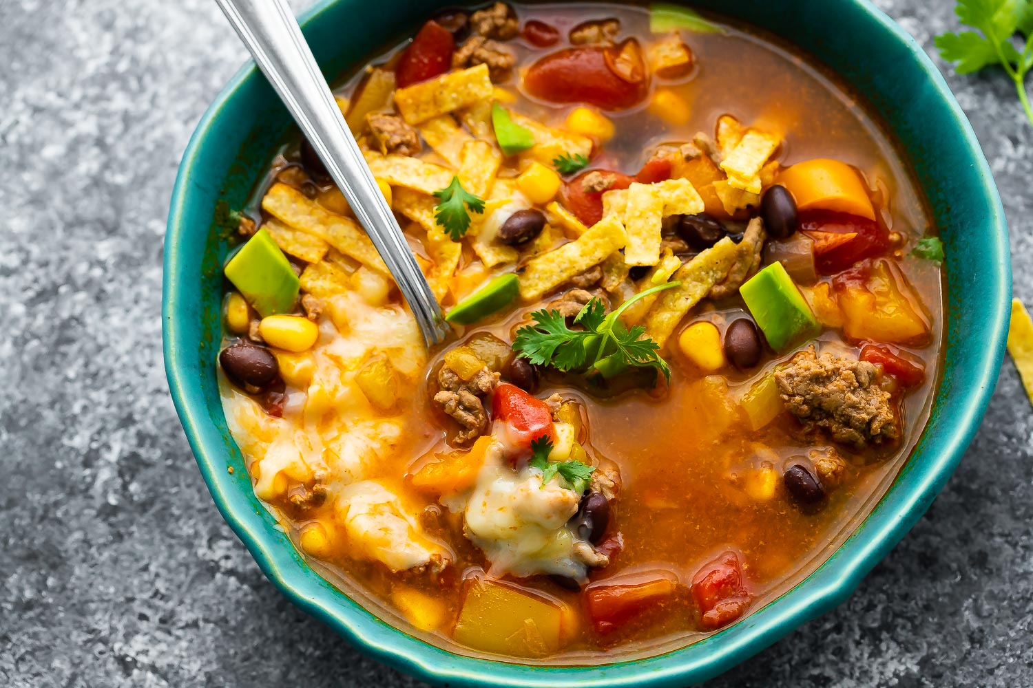 overhead view of taco soup in a bowl with spoon