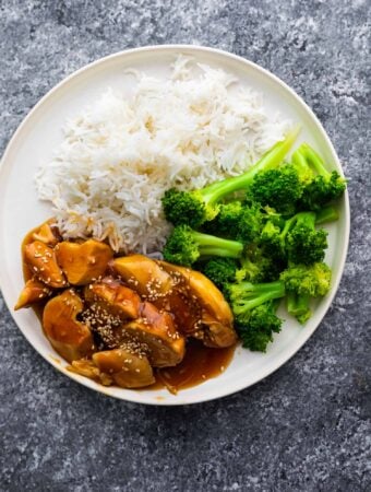 overhead view of teriyaki chicken on plate with rice and broccoli