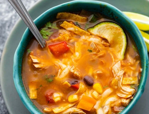 chicken tortilla soup in blue bowl with spoon