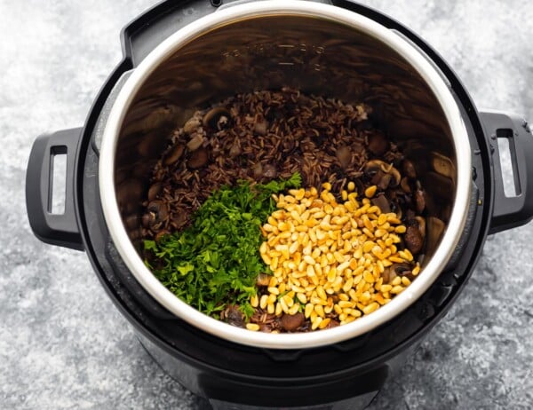 stirring parsley and pine nuts into the instant pot wild rice pilaf