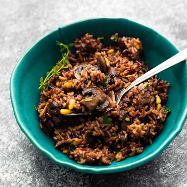 instant pot wild rice pilaf in blue bowl with fork