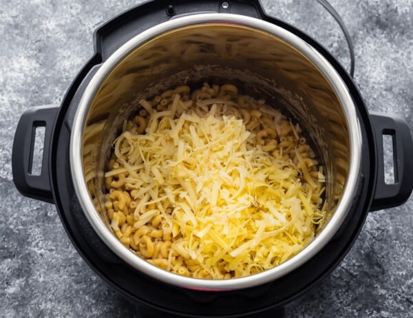 overhead view of cheese added to macaroni in the instant pot