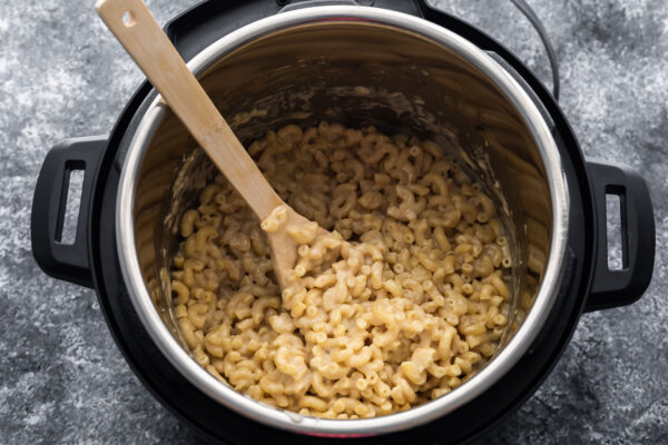 macaroni and cheese in instant pot with wooden spoon