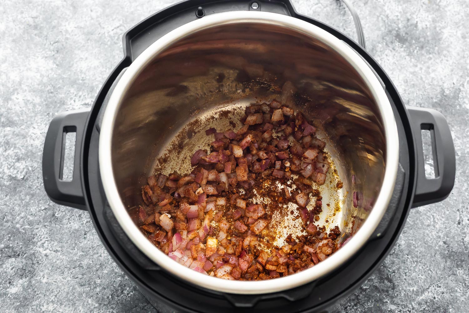 onions, garlic and chicken chili spices in instant pot