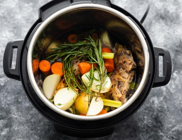 overhead view of ingredients for chicken stock in instant pot before cooking