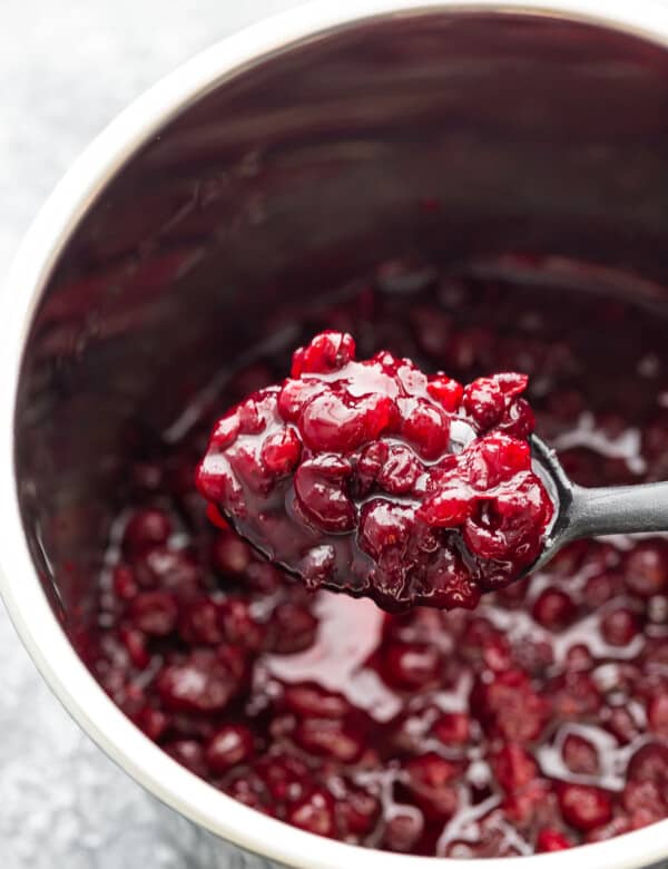 cranberry sauce on spoon lifted out of instant pot