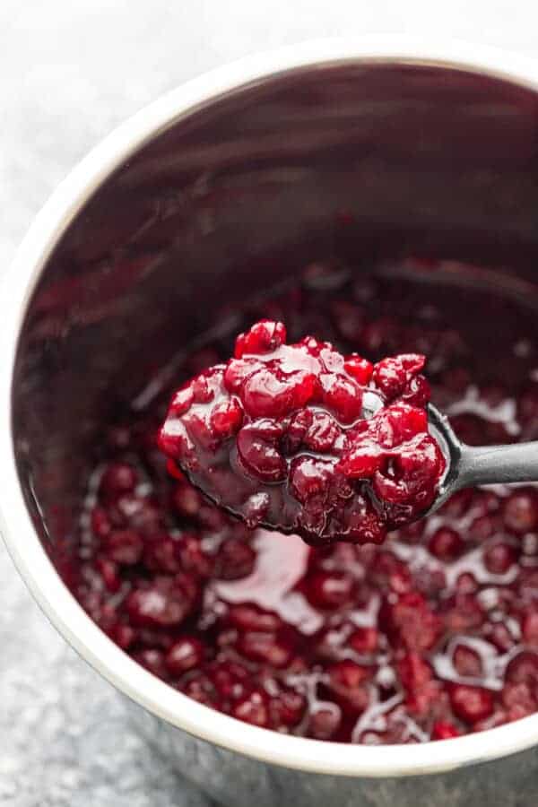 cranberry sauce on spoon lifted out of instant pot