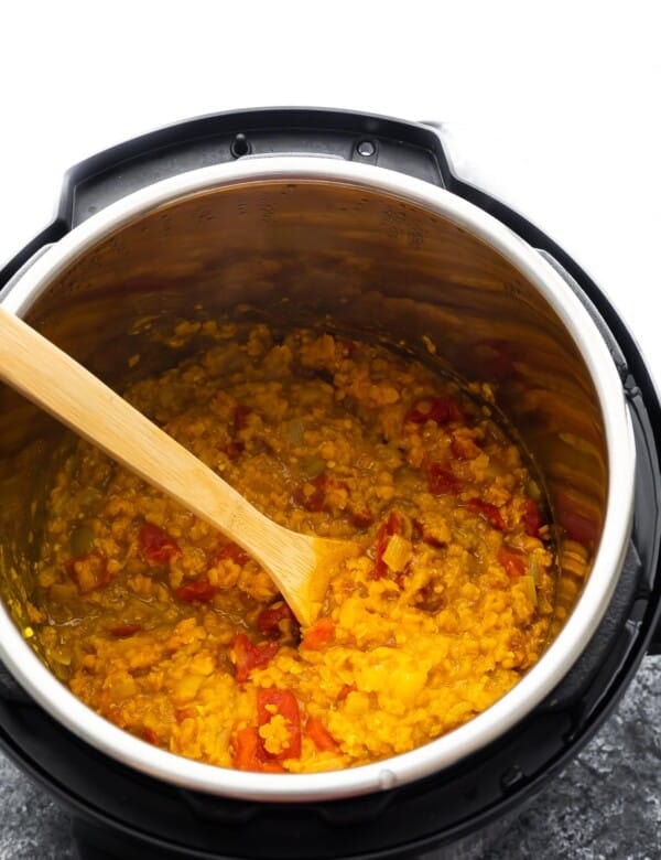 cooked dal in instant pot with wooden spoon
