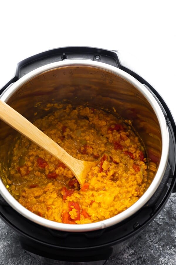 cooked dal in instant pot with wooden spoon