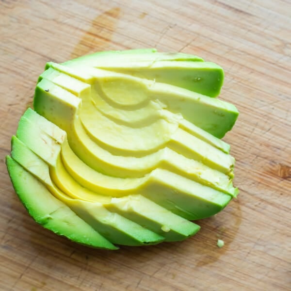 avocado sliced and fanned out on cutting board