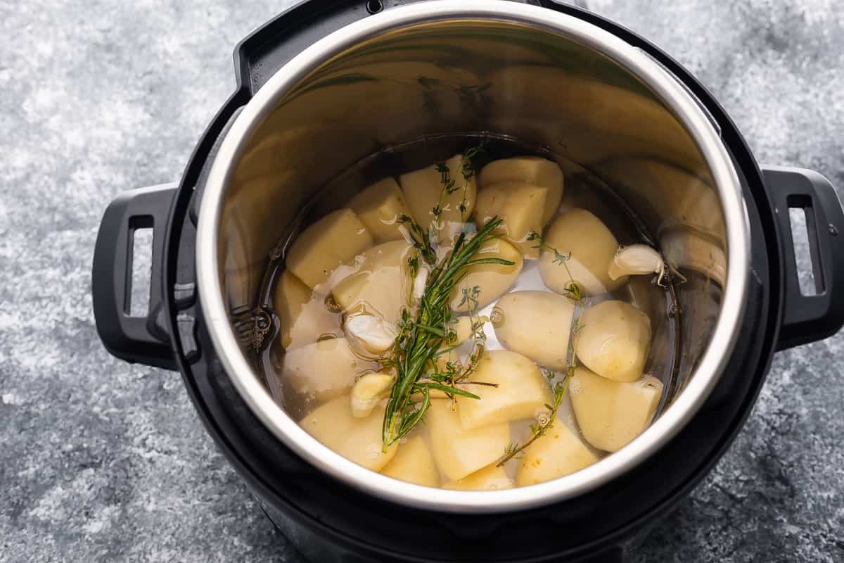 potatoes and herbs in instant pot before cooking