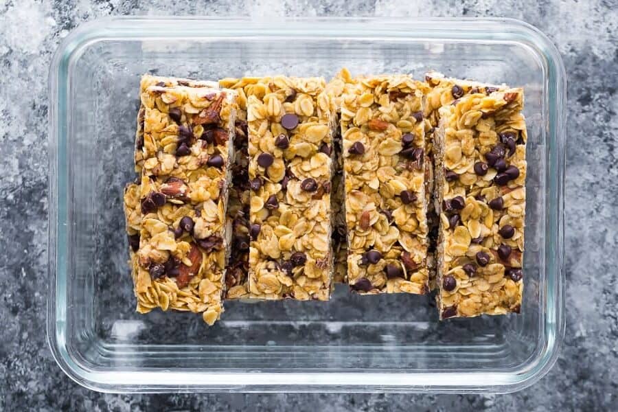 granola bars from above in glass meal prep container on grey surface