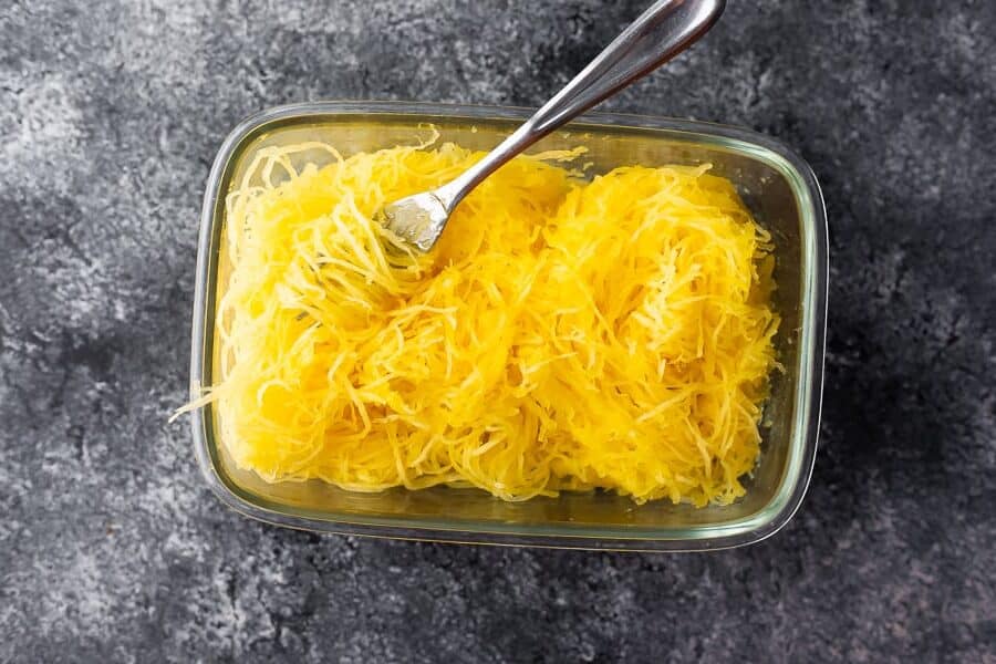meal prepped spaghetti squash in meal prep container with fork from above
