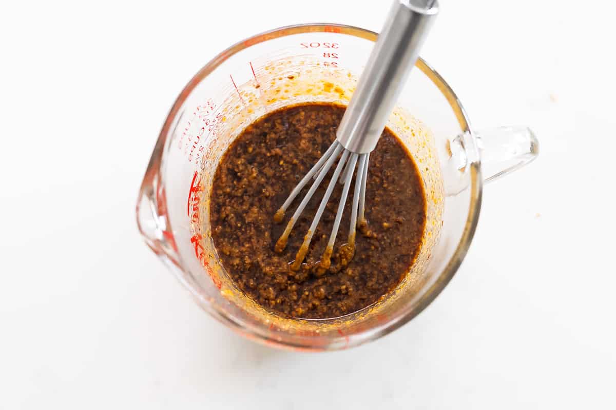 peanut sauce ingredients mixing up in measuring cup