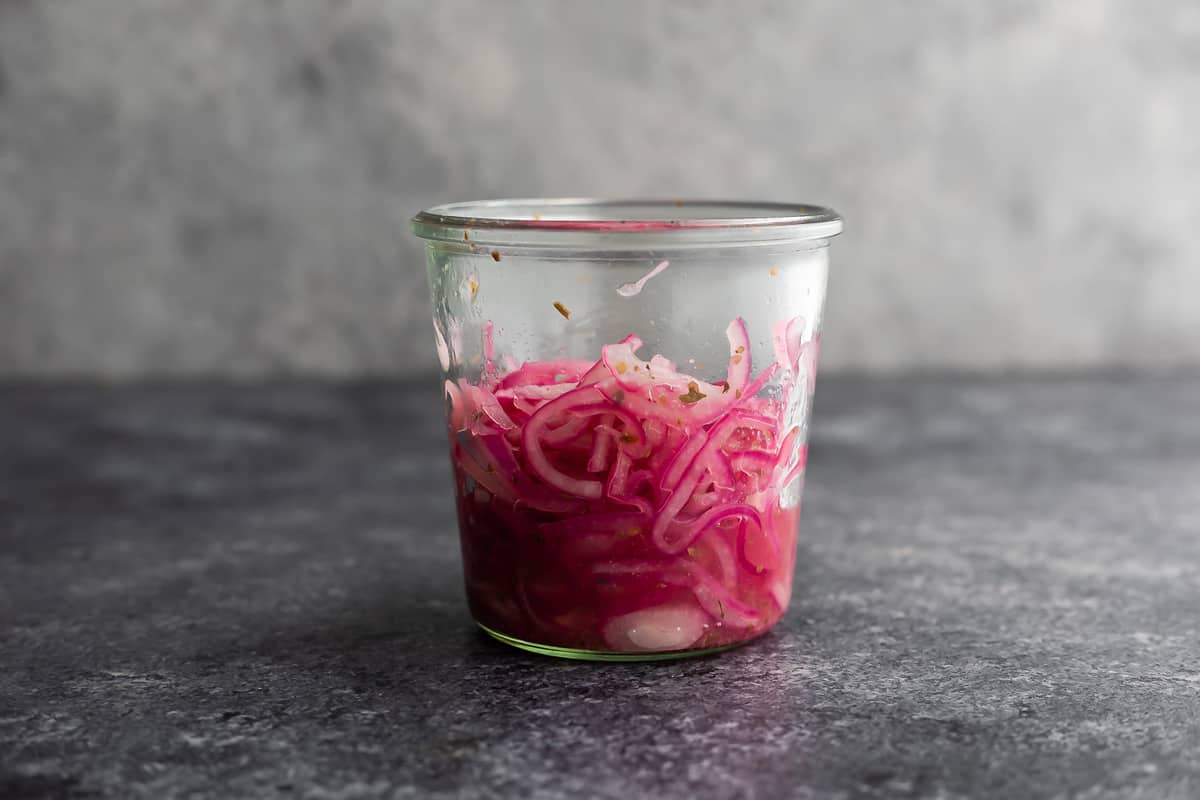side view of pickled onions in jar