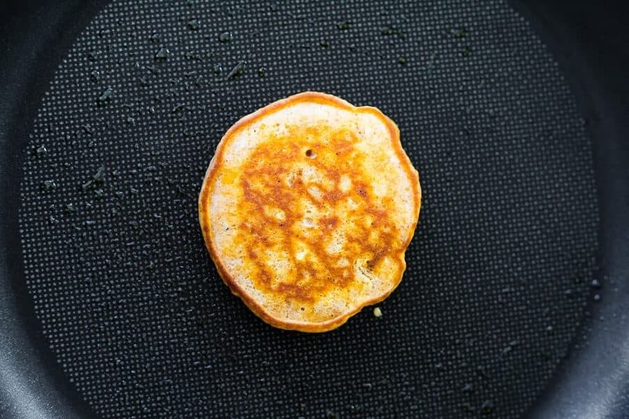 cooking a sweet potato pancake in nonstick pan, after flipping