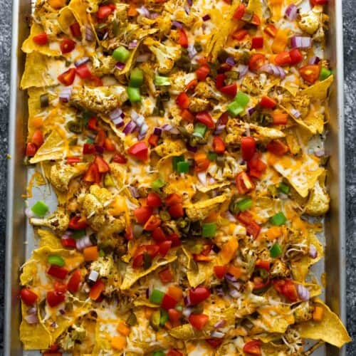 cauliflower nachos on sheet pan after melting