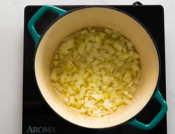 onions sauteeing in blue pot