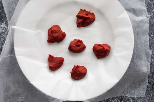 frozen tomato paste on wax paper lined plate