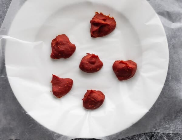 frozen tomato paste on wax paper lined plate