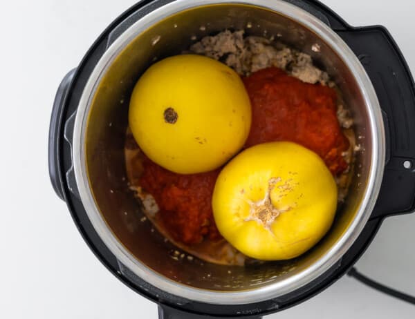 overhead view of spaghetti squash and meatsauce in instant pot before cooking