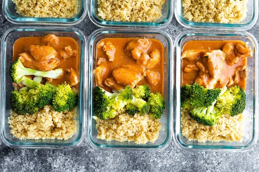overhead view of healthy butter chicken in meal prep containers
