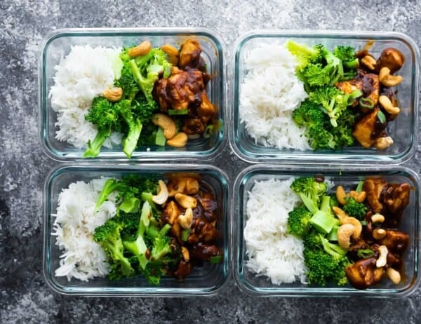 cashew chicken portioned out with rice and broccoli in meal prep containers