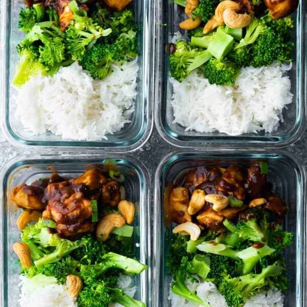 cashew chicken portioned out with rice and broccoli in meal prep containers