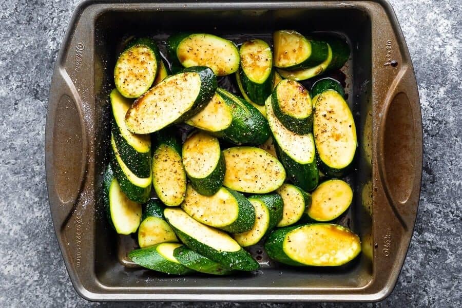 marinating zucchini in baking dish for the grilled zucchini recipe