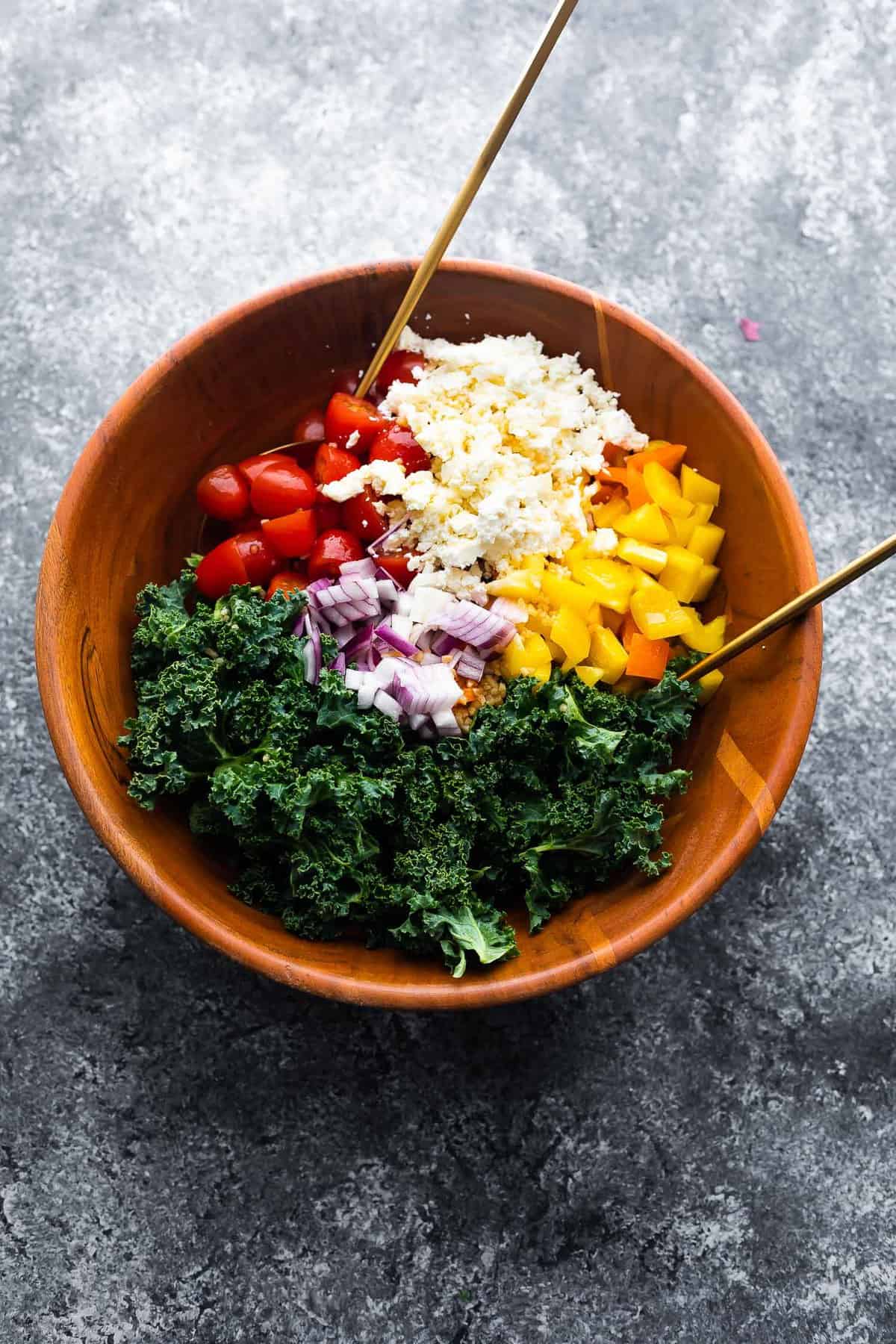 kale quinoa salad with vinaigrette before tossing up