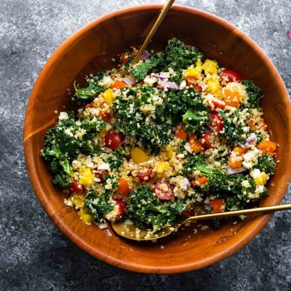 kale quinoa salad in wooden bowl all mixed up