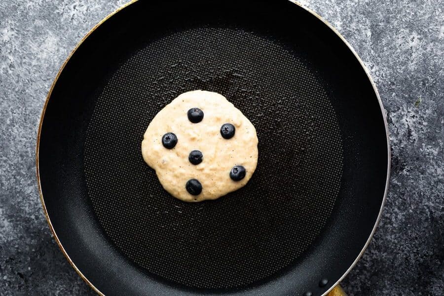 showing how to make blueberry pancakes in nonstick skillet