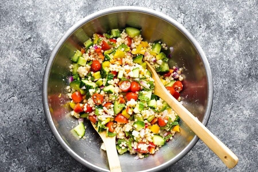 summer couscous salad from overhead in stainless steel mixing bowl