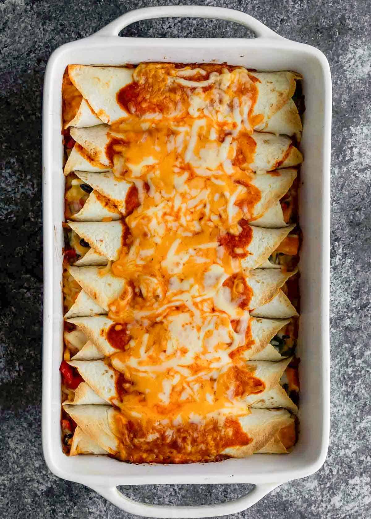 a casserole dish filled with vegetarian enchiladas