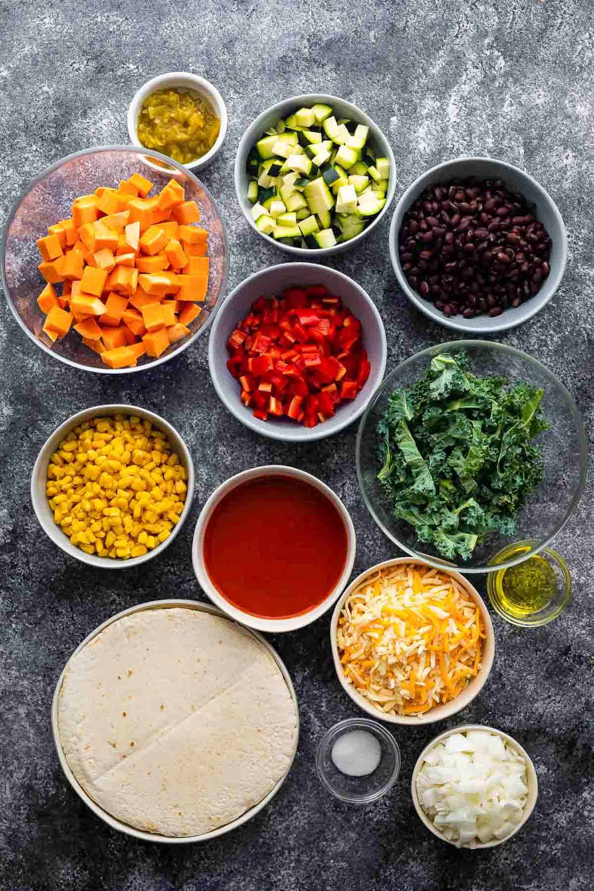 an overhead shot of the ingredients for vegetarian enchiladas