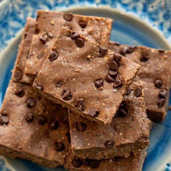 An overhead shot of homemade protein bars on a blue plate