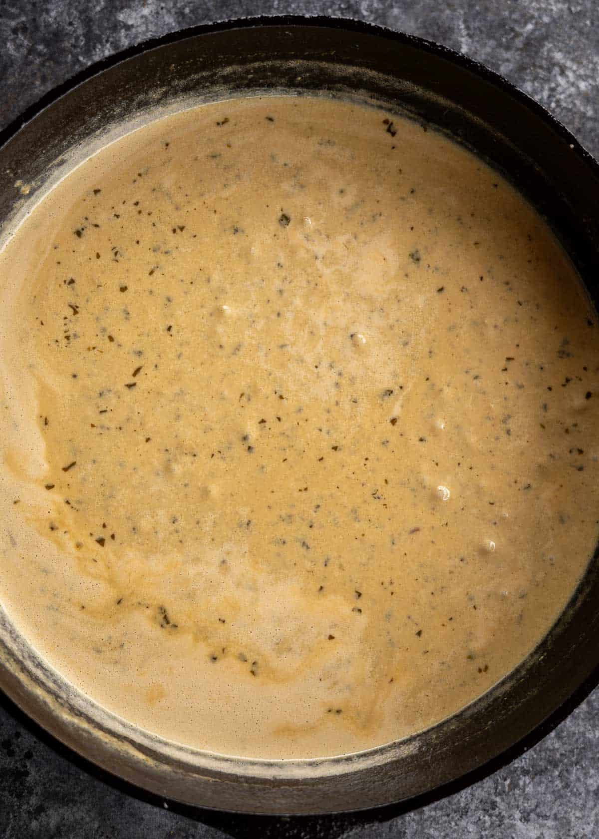 pesto alfredo in a cast iron skillet