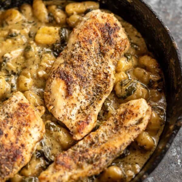cooked pesto chicken gnocchi in a skillet
