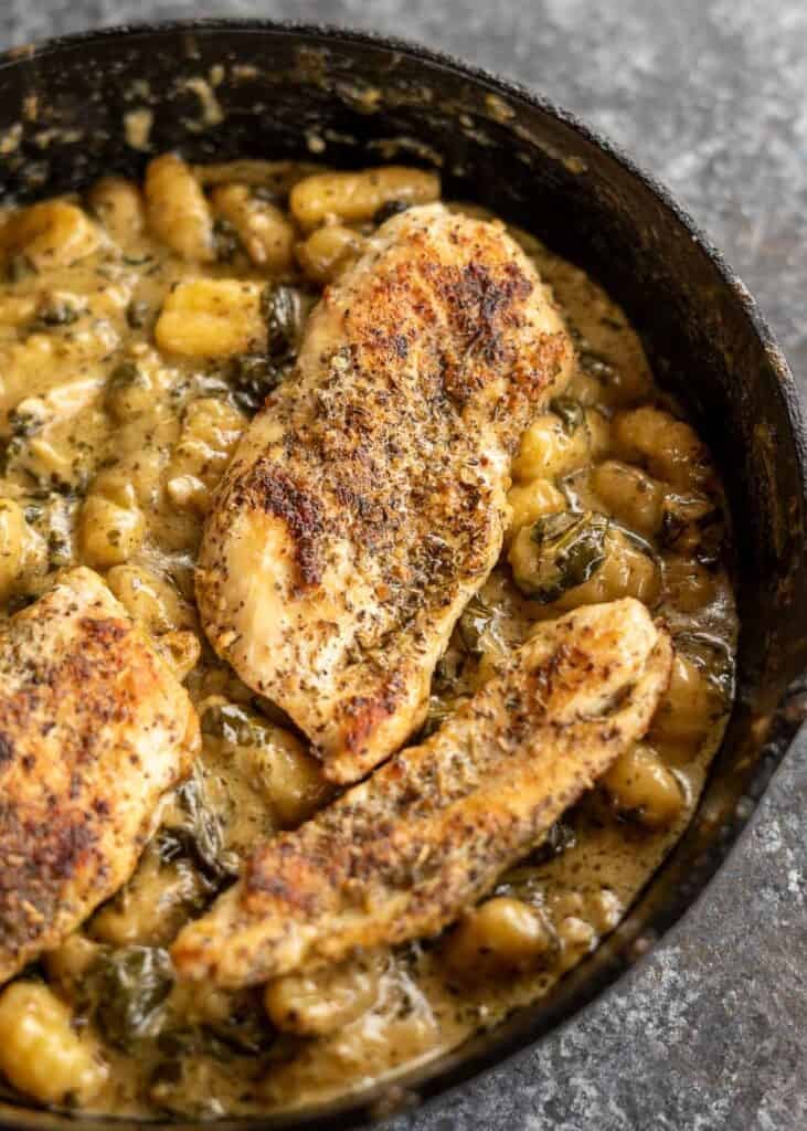 cooked pesto chicken gnocchi in a skillet