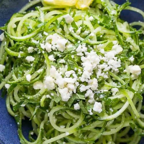 cucumber salad with feta and lemon wedges